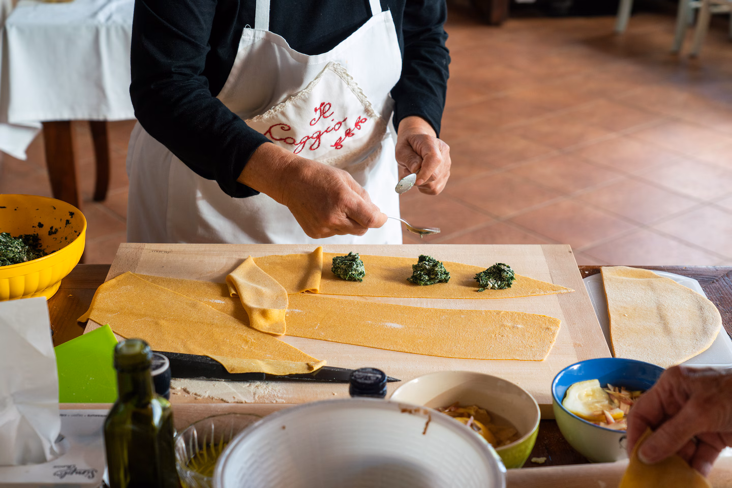 Illustrated chef preparing a dish in a bright cooking classroom