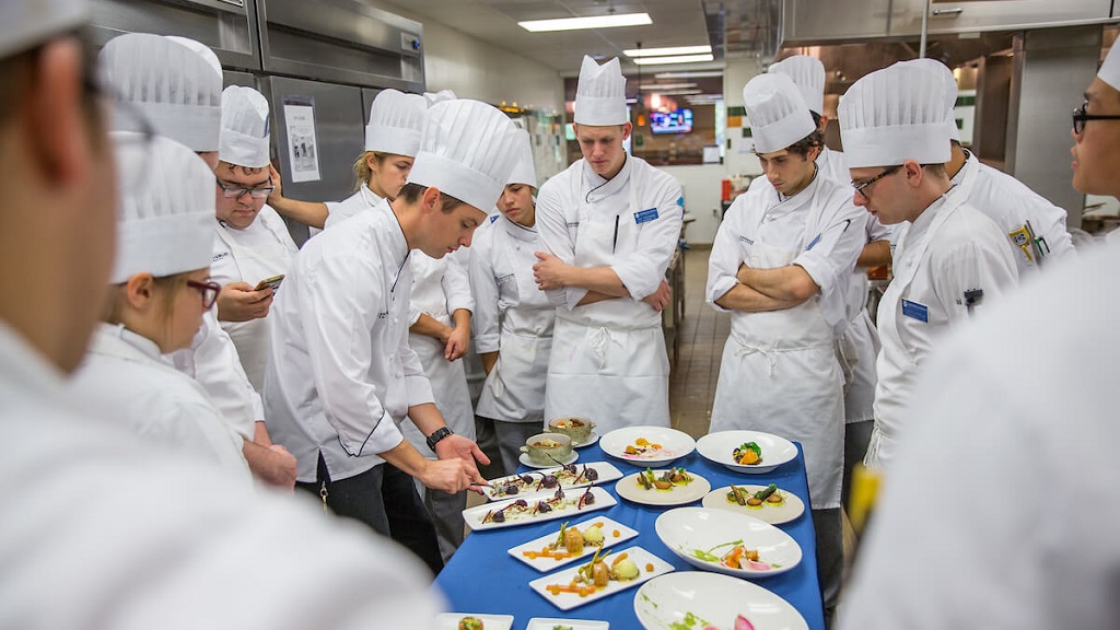 Illustrated cooking students learning practical culinary techniques